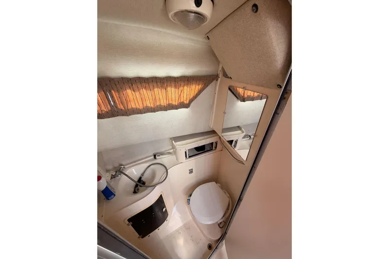 Slide: The Image of 1993 Grady-White Marlin 300 boat bathroom interior with toilet and mirror. - 33
