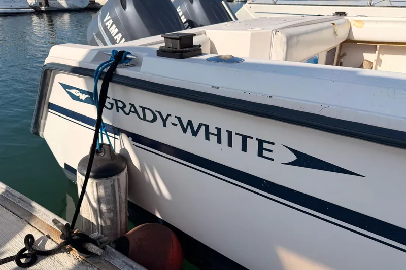 Slide: The Image of 1993 Grady-White Marlin 300 boat docked with Yamaha engines visible. - 37
