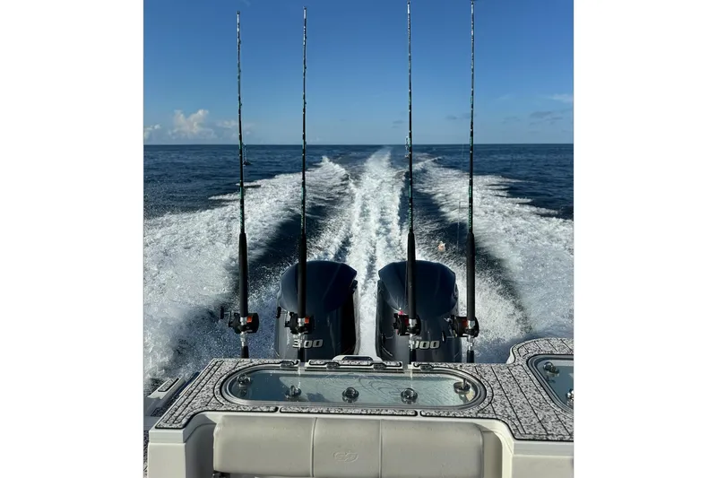 Slide: The Image of Sea Fox 288 Commander 2021 boat with fishing rods and dual engines on open water. - 10