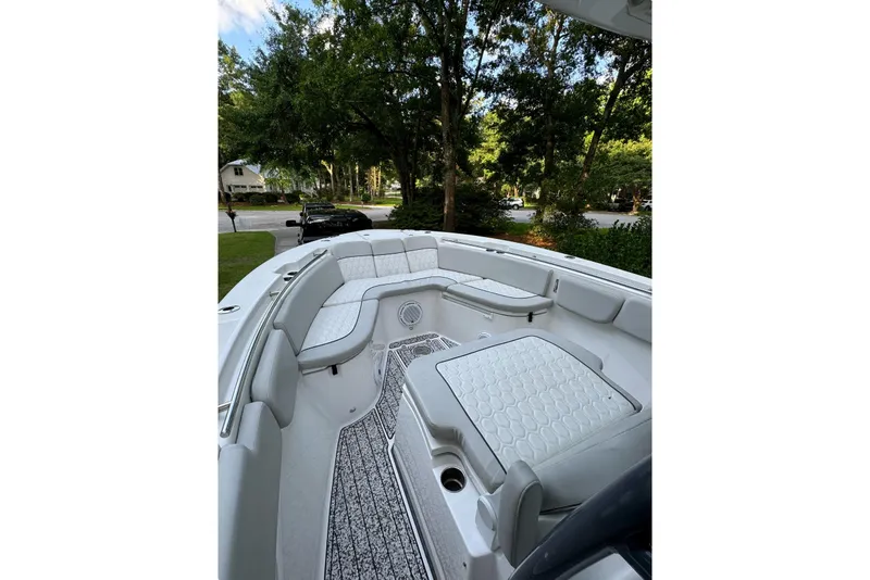 Slide: The Image of 2021 Sea Fox 288 Commander boat parked in a residential driveway, surrounded by trees. - 3