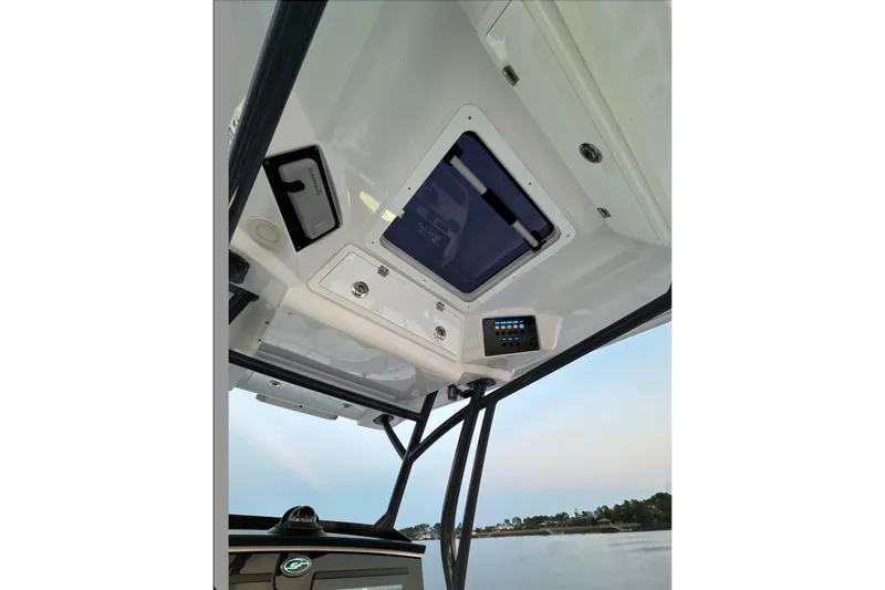 Slide: The Image of 2021 Sea Fox 288 Commander boat interior ceiling view with control panel. - 8