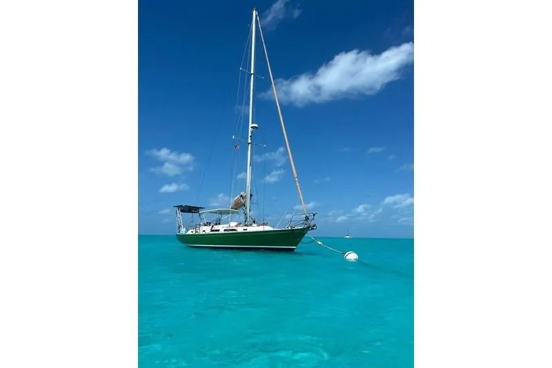 Slide: The Image of Green 1989 Hylas 44 sailboat on stands under a clear blue sky. - 1