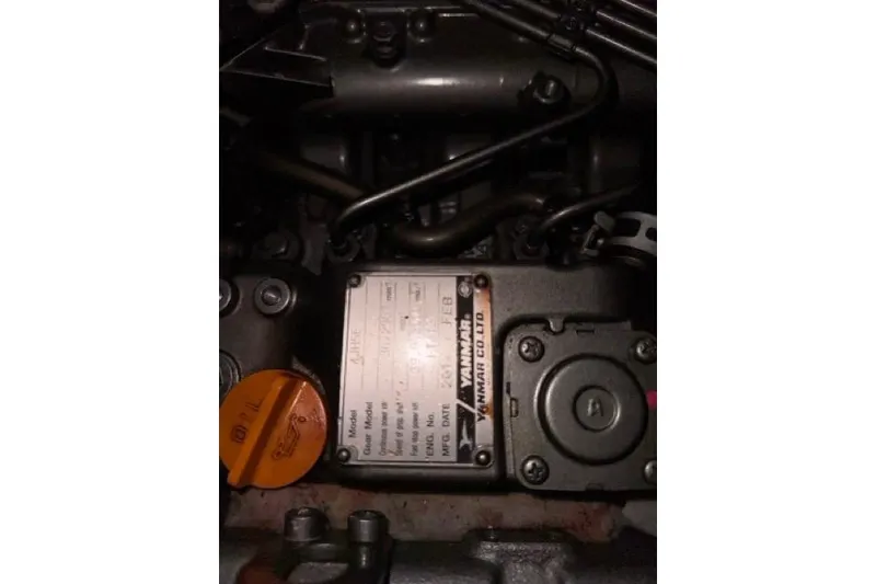 Slide: The Image of Engine compartment of a 1989 Hylas 44 sailboat, featuring Yanmar components. - 102