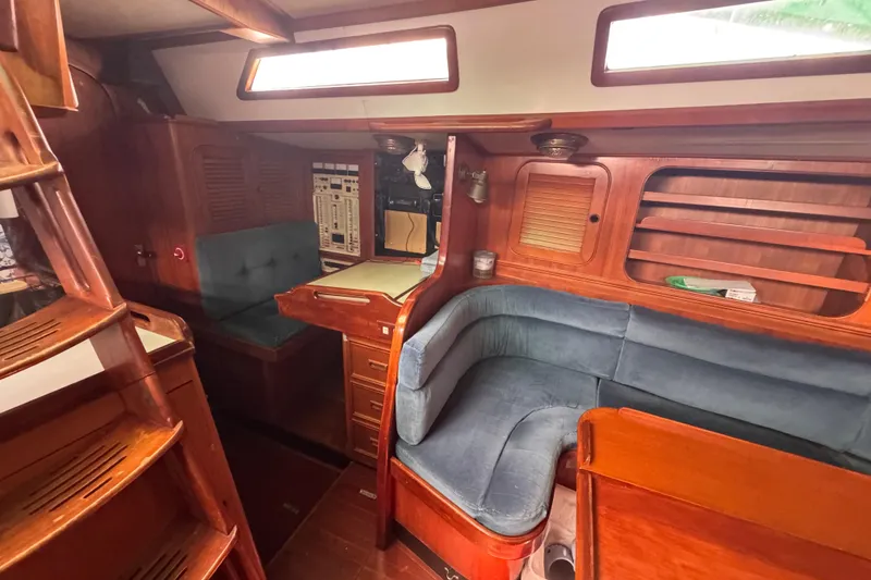 Slide: The Image of Interior of 1989 Hylas 44 sailboat with wooden cabinetry and blue seating. - 106