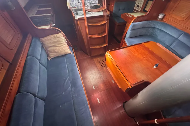 Slide: The Image of Interior of 1989 Hylas 44 yacht with blue seating and wooden table. - 107