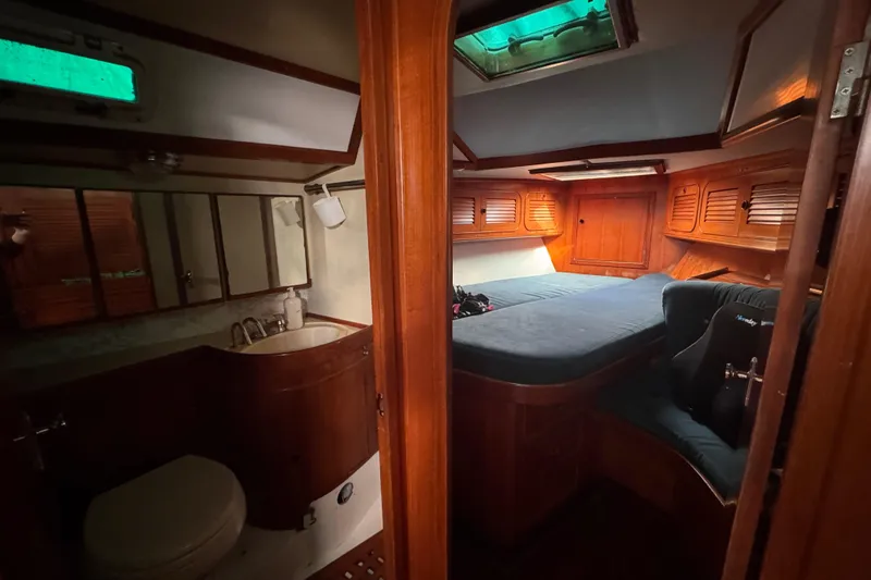 Slide: The Image of Cozy cabin interior of 1989 Hylas 44 yacht with wooden furnishings and skylight. - 110