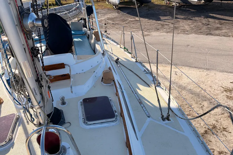 Slide: The Image of 1989 Hylas 44 sailboat deck with rigging and seating, docked on land. - 120