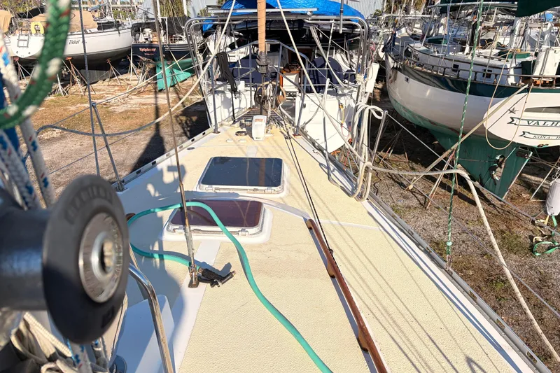 Slide: The Image of 1989 Hylas 44 sailboat on land, deck view with ropes and equipment. - 122