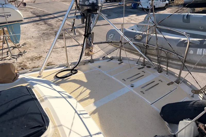 Slide: The Image of 1989 Hylas 44 sailboat deck with dinghy and equipment, docked on land. - 126