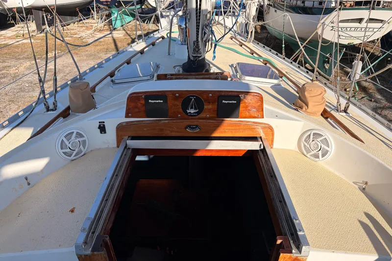 Slide: The Image of 1989 Hylas 44 sailboat deck with open hatch and navigation equipment. - 127