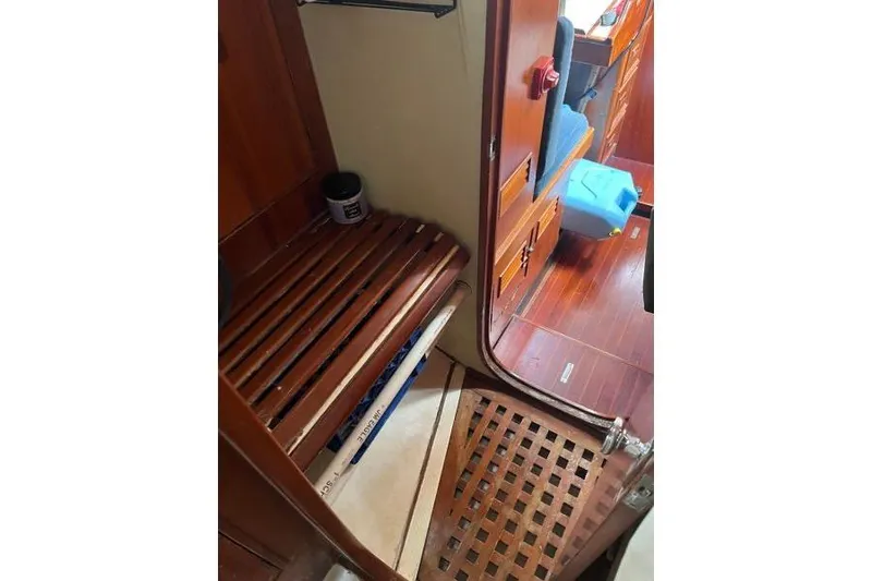 Slide: The Image of Green 1989 Hylas 44 sailboat on dry dock, supported by stands, under a clear blue sky. - 3