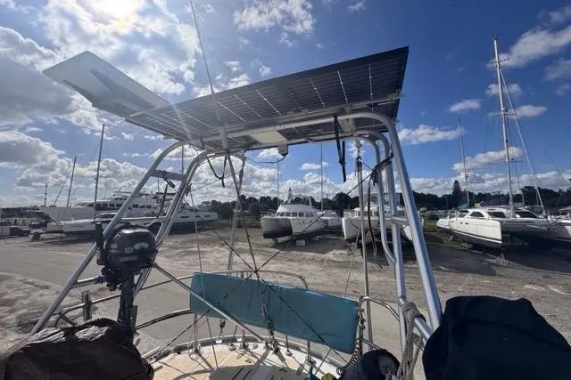 Slide: The Image of Sailboat with solar panel, Hylas 44 model, 1989, docked under a blue sky. - 31