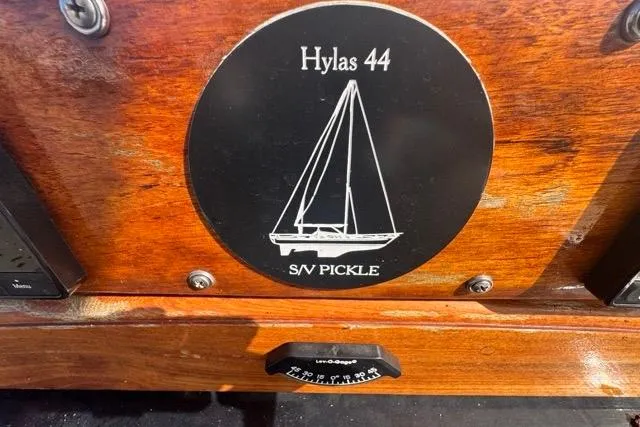 Slide: The Image of Plaque of 1989 Hylas 44 sailboat, S/V Pickle, on wooden surface. - 41