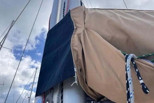 Slide: The Image of Close-up of a 1989 Hylas 44 sailboat mast with rigging and sail cover. - 46