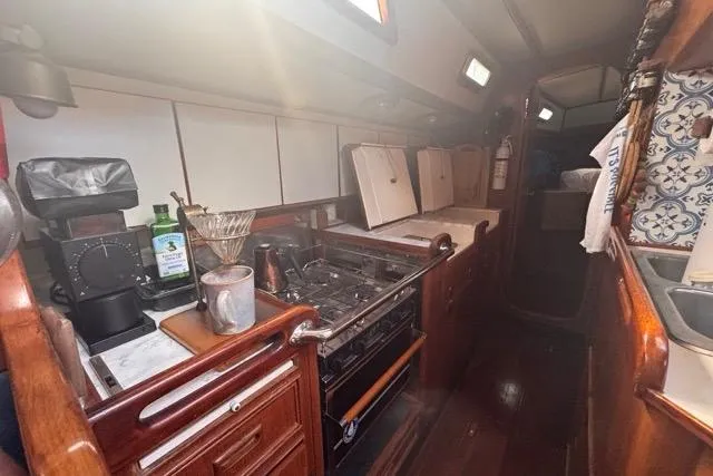 Slide: The Image of Interior of 1989 Hylas 44 yacht kitchen with wooden cabinetry and modern appliances. - 53