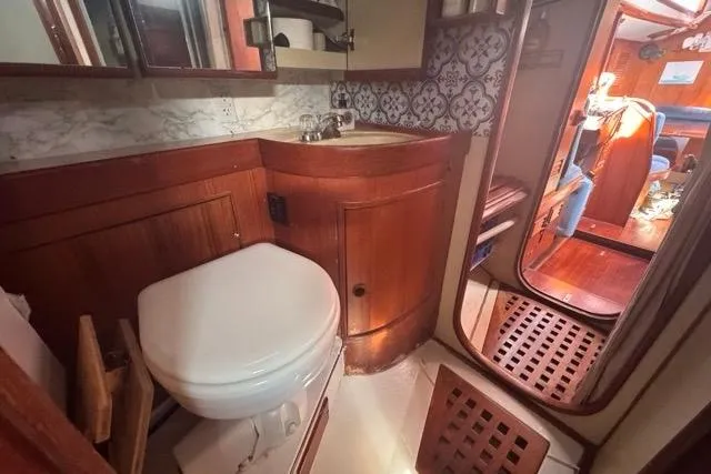 Slide: The Image of 1989 Hylas 44 yacht bathroom with wooden cabinetry and nautical decor. - 59