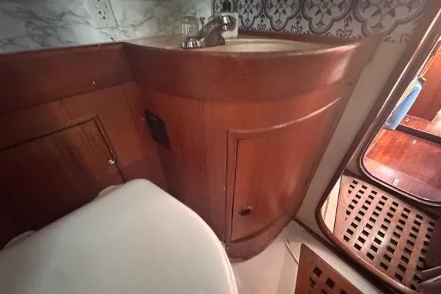 Slide: The Image of Wooden bathroom interior of 1989 Hylas 44 yacht with sink and patterned wall. - 60