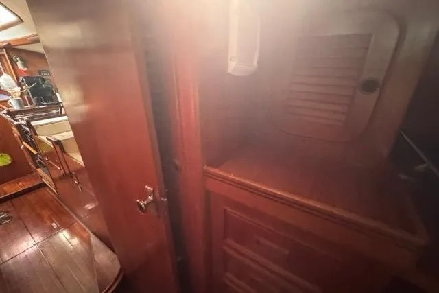 Slide: The Image of Interior of 1989 Hylas 44 sailboat with wooden cabinetry and flooring. - 63