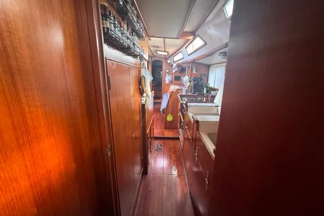 Slide: The Image of Interior view of 1989 Hylas 44 sailboat with wooden cabinetry and cozy layout. - 64