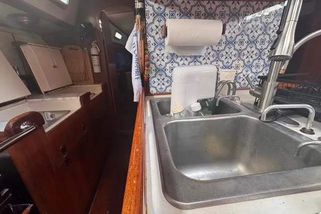 Slide: The Image of Interior of 1989 Hylas 44 yacht kitchen with sink and patterned backsplash. - 65