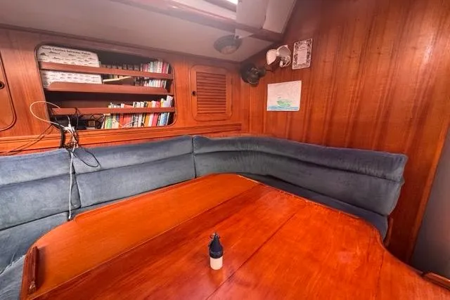 Slide: The Image of Cozy interior of 1989 Hylas 44 sailboat with wooden table and bookshelf. - 67