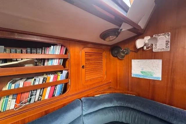 Slide: The Image of Cozy cabin interior of 1989 Hylas 44 sailboat with bookshelves and seating. - 68