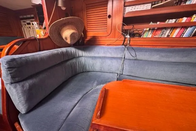 Slide: The Image of Cozy interior of 1989 Hylas 44 yacht with blue seating and wooden accents. - 69