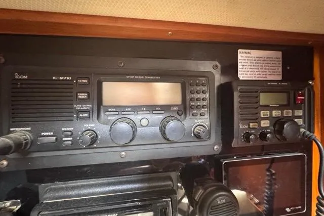 Slide: The Image of Radio equipment on a 1989 Hylas 44 sailboat, featuring Icom communication devices. - 70