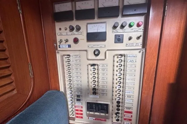 Slide: The Image of Electrical control panel on a 1989 Hylas 44 yacht, featuring switches and gauges. - 71