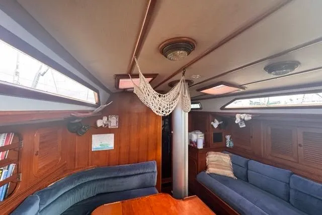 Slide: The Image of Interior of 1989 Hylas 44 sailboat with cozy seating and wooden finishes. - 72