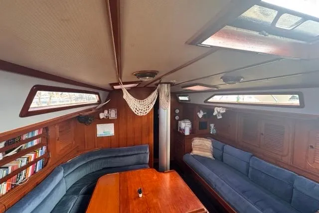 Slide: The Image of Interior of 1989 Hylas 44 sailboat with wooden furnishings and blue seating. - 73