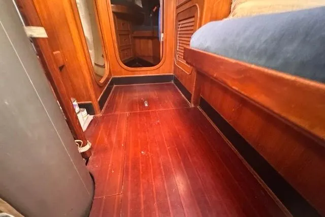 Slide: The Image of Interior of 1989 Hylas 44 sailboat with wooden flooring and cozy cabin space. - 74