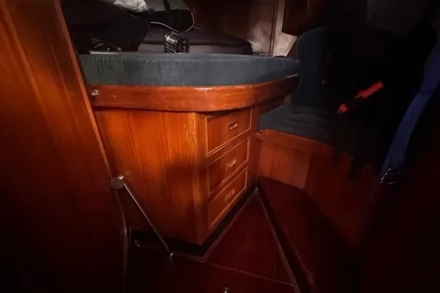 Slide: The Image of Interior of 1989 Hylas 44 sailboat with wooden drawers and seating area. - 76