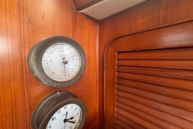 Slide: The Image of Interior of 1989 Hylas 44 yacht with barometer and clock on wooden paneling. - 77