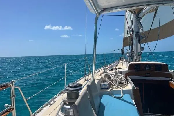 Slide: The Image of 1989 Hylas 44 sailboat on stands, green hull, sunny day, clear sky. - 8