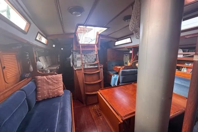 Slide: The Image of Interior of 1989 Hylas 44 sailboat with wooden furnishings and blue seating. - 80