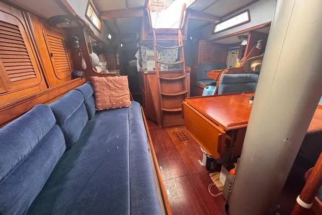 Slide: The Image of Interior of 1989 Hylas 44 sailboat with wooden furnishings and blue seating. - 81
