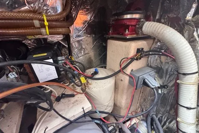 Slide: The Image of Engine compartment of a 1989 Hylas 44 sailboat, showing wiring and components. - 86