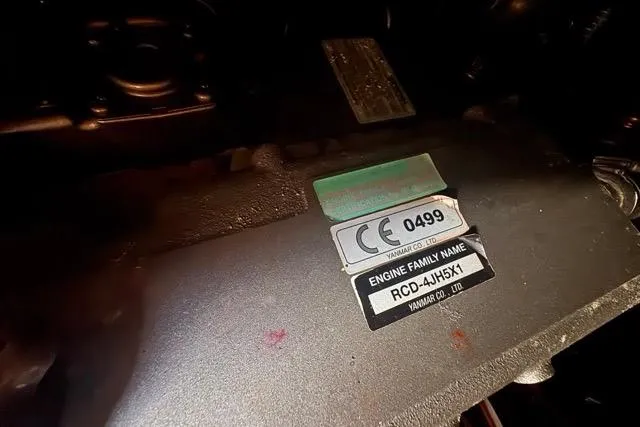 Slide: The Image of Engine label of a 1989 Hylas 44, featuring Yanmar RCD-4JH5X1 details. - 89