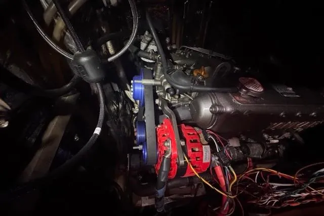 Slide: The Image of Engine compartment of a 1989 Hylas 44 sailboat, featuring visible wiring and components. - 95