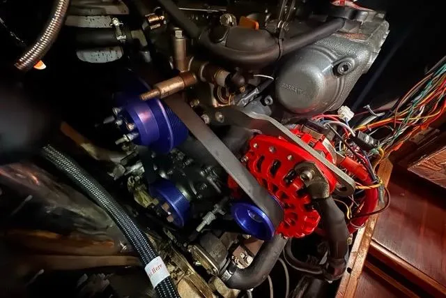 Slide: The Image of Engine compartment of a 1989 Hylas 44 sailboat, showcasing mechanical components and wiring. - 96