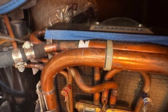 Slide: The Image of Copper piping system in a 1989 Hylas 44 yacht engine compartment. - 99