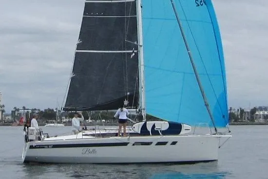 The Image of 2021 Jeanneau Sun Odyssey 349 sailboat with blue and black sails on calm water. - 0