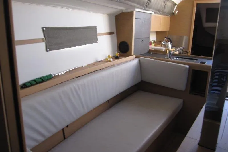 Slide: The Image of Interior of 2021 Jeanneau Sun Odyssey 349 sailboat with modern kitchen and seating area. - 10