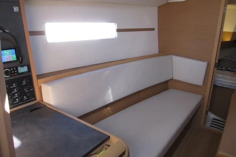 Slide: The Image of Interior of 2021 Jeanneau Sun Odyssey 349 sailboat with modern seating and control panel. - 12