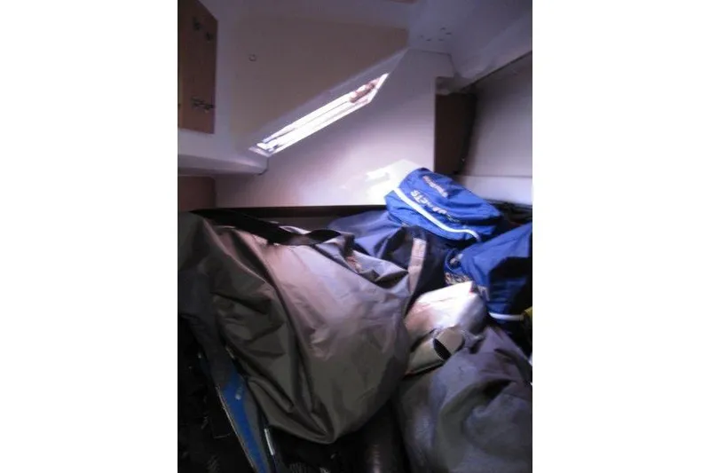 Slide: The Image of Interior cabin of 2021 Jeanneau Sun Odyssey 349 with bags and gear. - 20