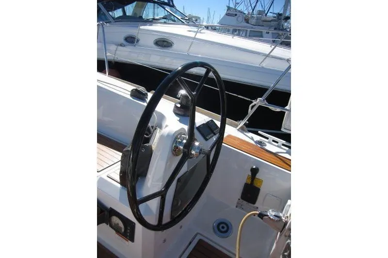 Slide: The Image of Steering wheel of a 2021 Jeanneau Sun Odyssey 349 sailboat, docked in a marina. - 24