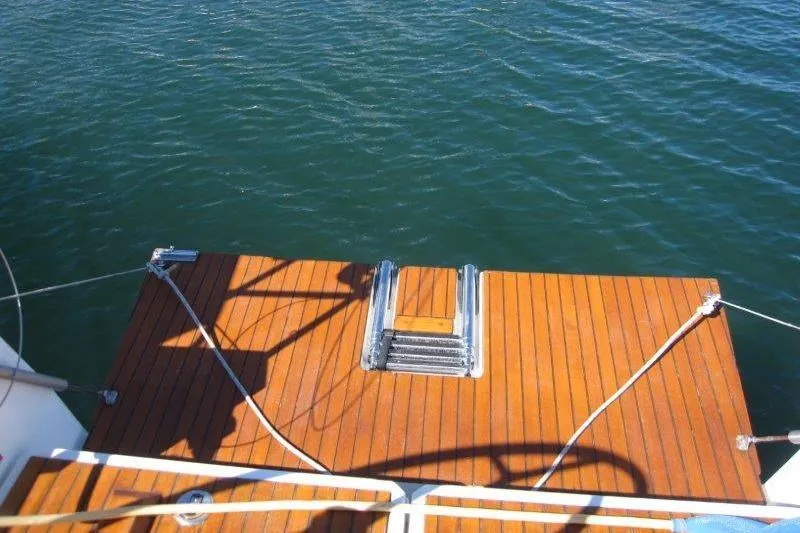Slide: The Image of Jeanneau Sun Odyssey 349, 2021 model, featuring a wooden swim platform on calm water. - 27