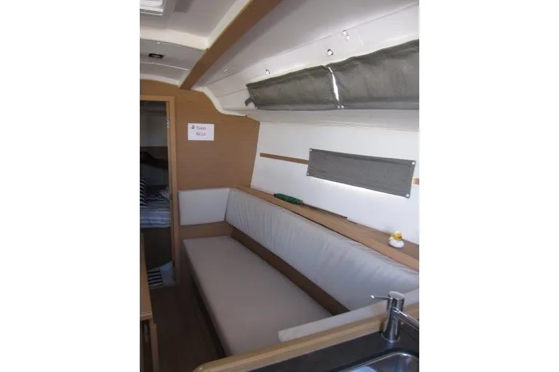 Slide: The Image of Interior of 2021 Jeanneau Sun Odyssey 349 sailboat, featuring a cozy seating area. - 3