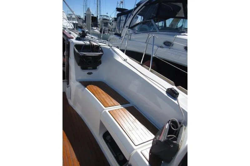 Slide: The Image of 2021 Jeanneau Sun Odyssey 349 sailboat cockpit with wooden seating and steering wheel. - 30